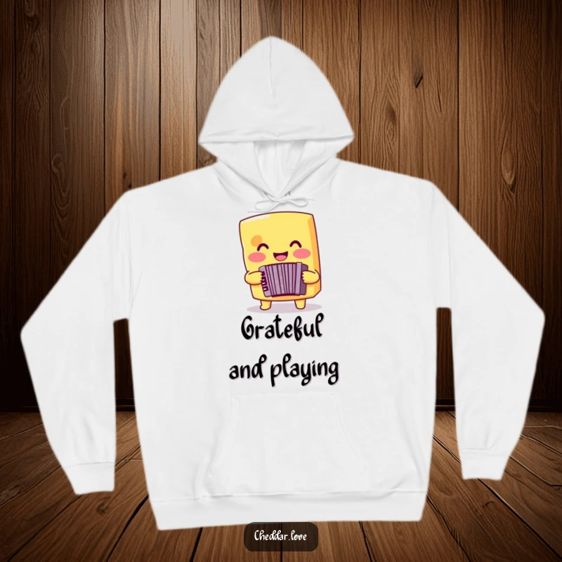 Funny cheese hoodie depicting a smiling cheddar cheese playing an accordion, ideal for cozy musical enjoyment.