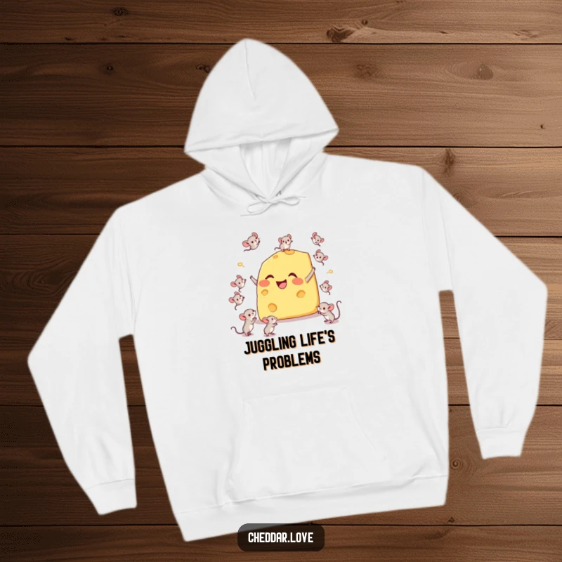Funny hoodie depicting a happy cheese wedge comically juggling tiny mice, showcasing a playful juggling act and cheesy charm.