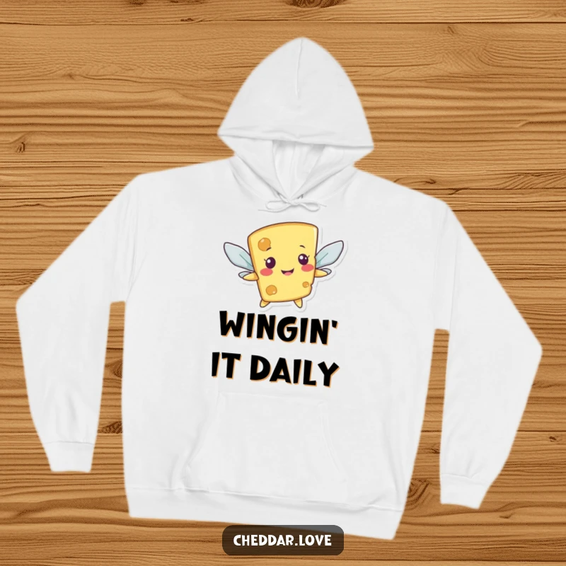 Funny hoodie depicting a smiling cheese character attempting flight with cracker wings, providing warmth and humor.